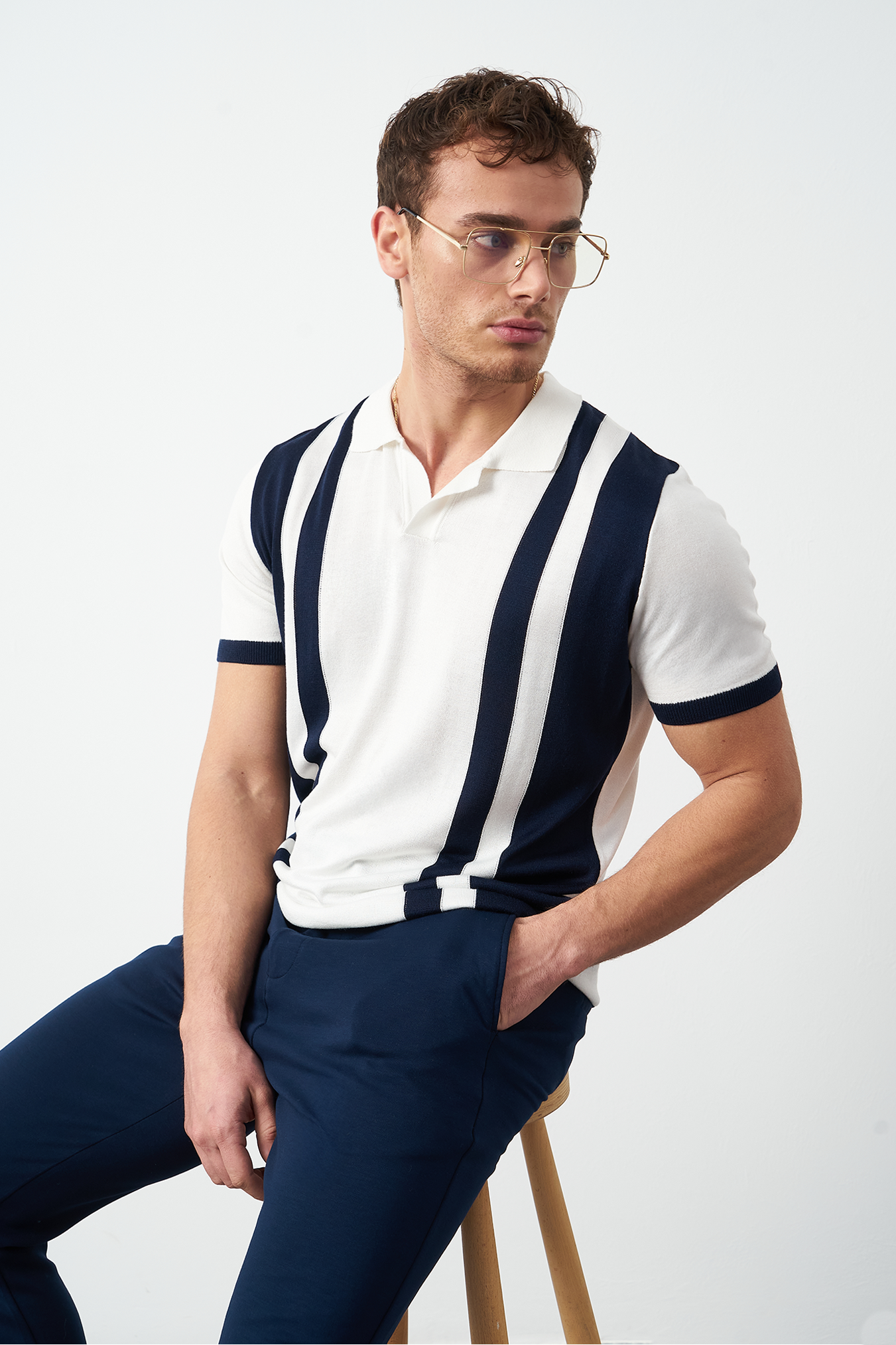 Oversized polo shirt side profile on model - Navy blue relaxed fit by Mesfeno Wear