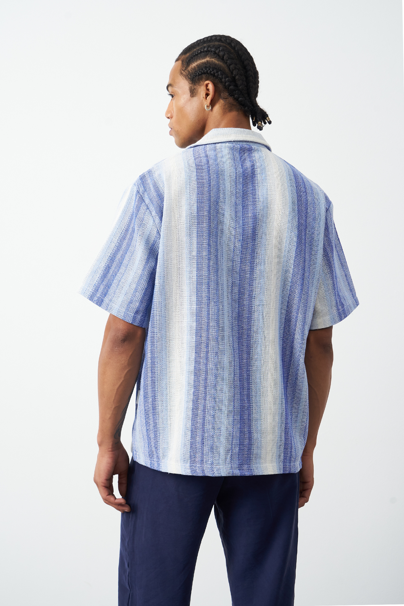 Light blue Cuban collar shirt styled casually, oversized striped camp collar for summer wear